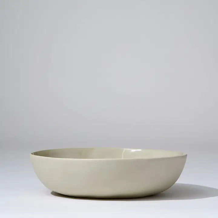 Beige ceramic bowl on a light gray background