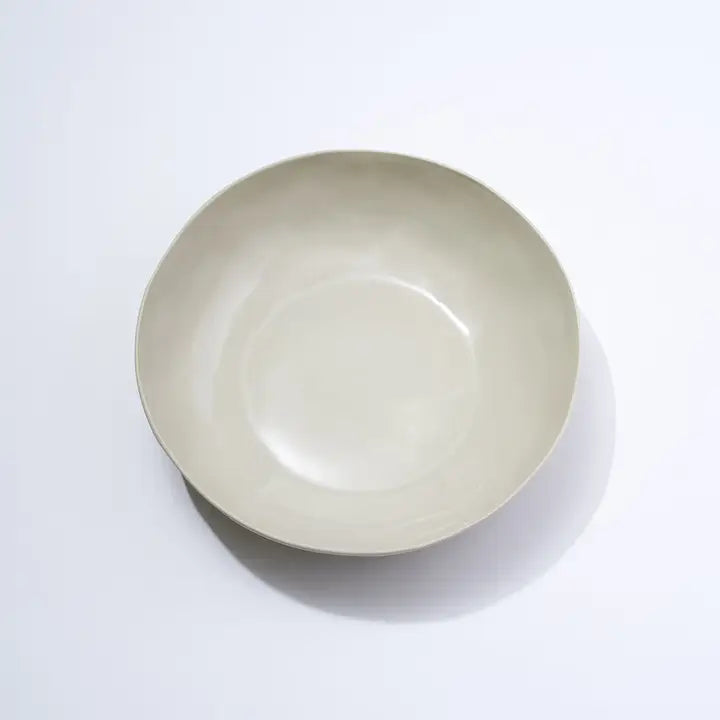 Beige ceramic bowl on a white background