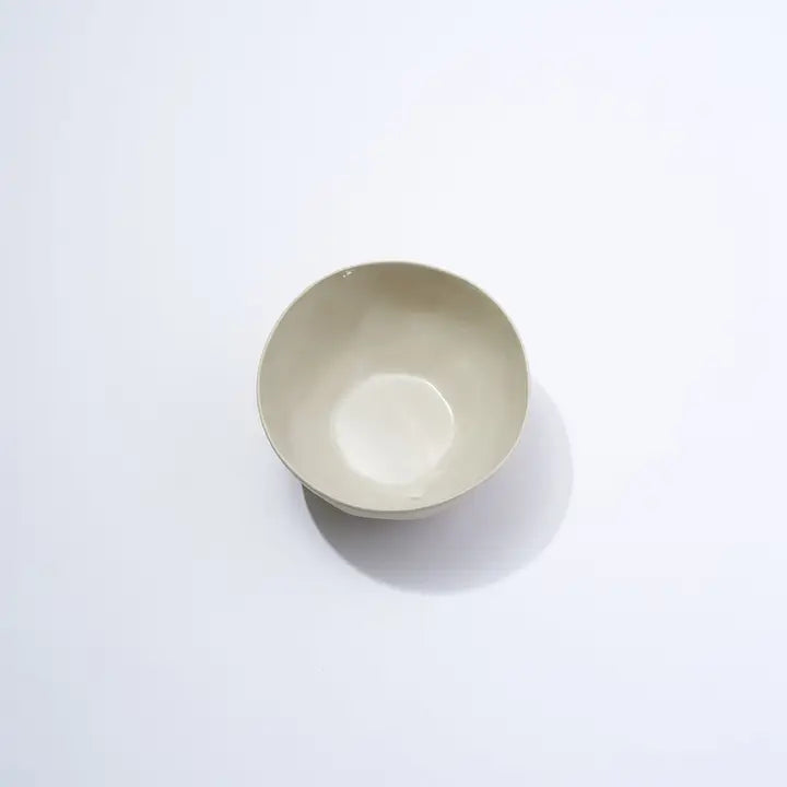 Beige ceramic bowl on a white background
