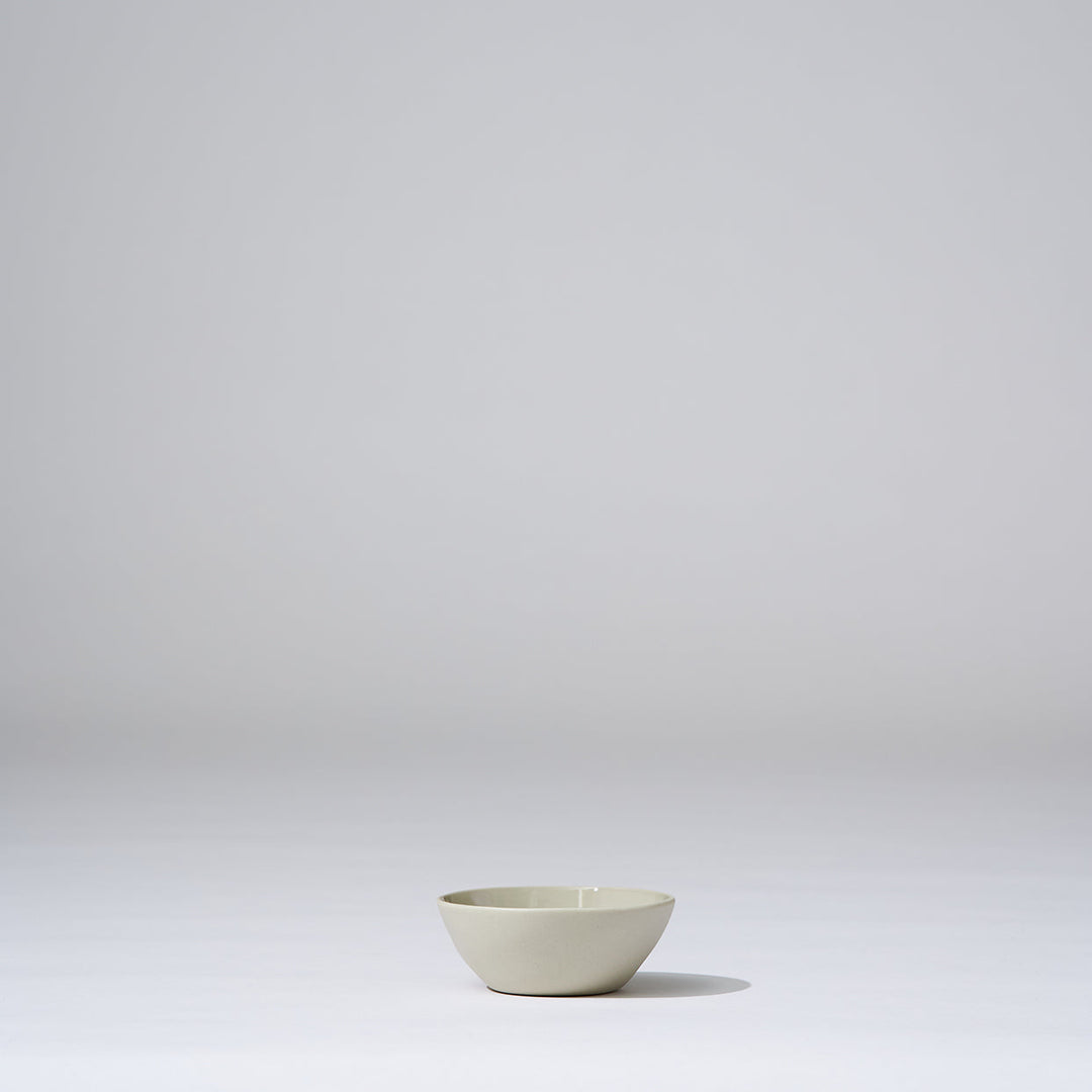 Small white bowl on a light gray background
