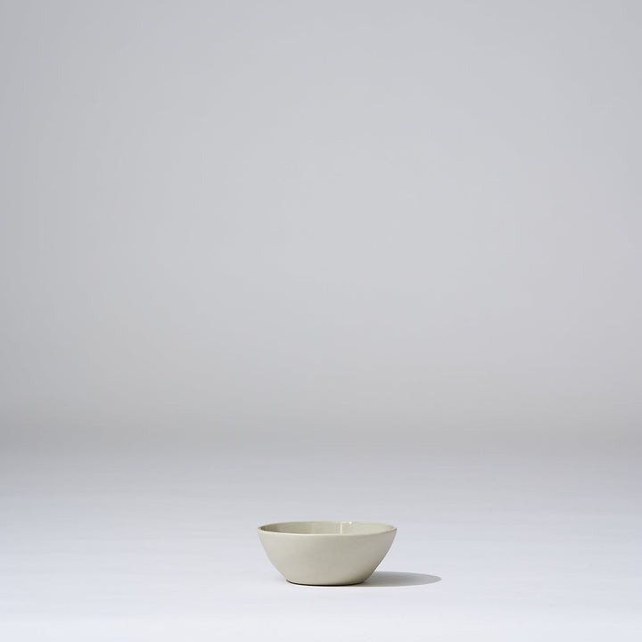 Small white bowl on a light gray background