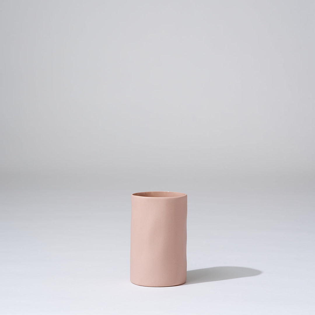 Pink ceramic vase on a light gray background