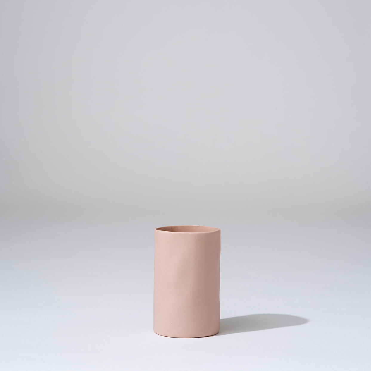 Pink ceramic vase on a light gray background