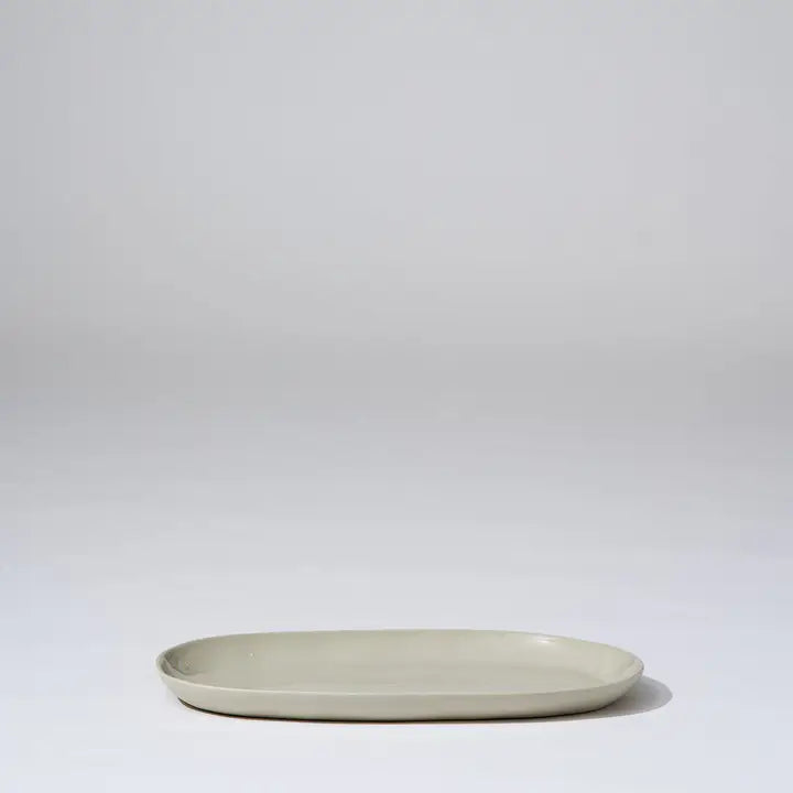 Beige ceramic oval plate on a light gray background