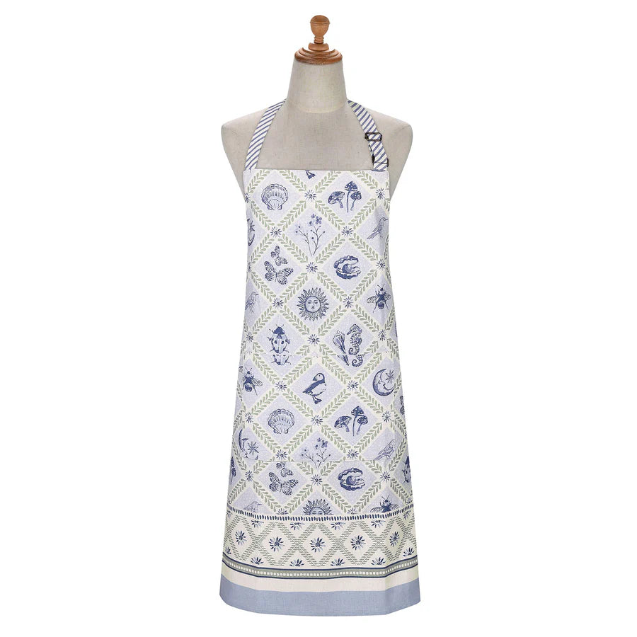 White apron with blue seaside pattern on a mannequin against a white background