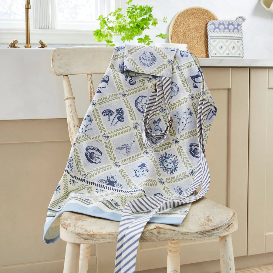Patterned apron draped over a wooden chair in a kitchen setting