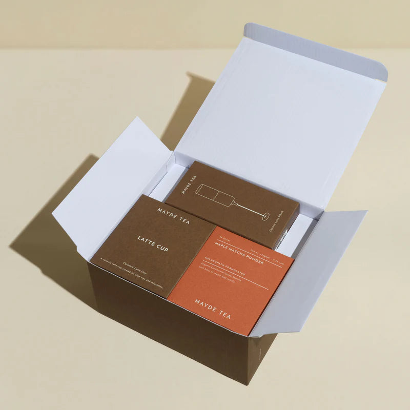 Mayde Tea packaging with latte cup and maple bacon powder on a beige background