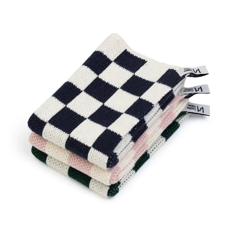 Stack of checkered dish towels with tags on a white background