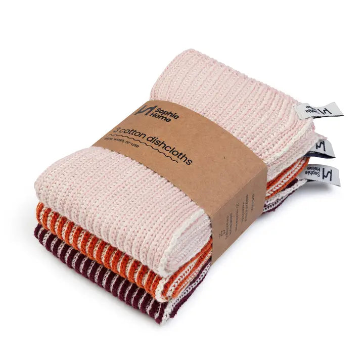 Stack of cotton dishcloths with a cardboard packaging label on a white background