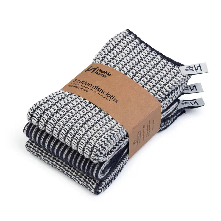 Pack of navy and white patterned cotton dishcloths with a cardboard sleeve on a white background