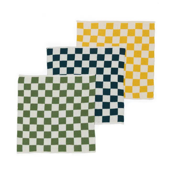 Three checkered placemats in green, blue, and yellow on a white background
