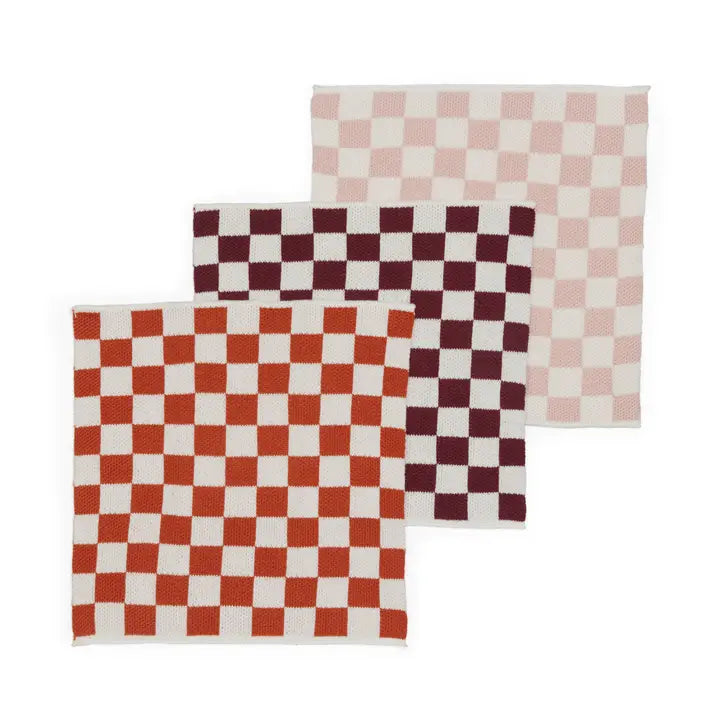 Three checkered dish cloths in red, white, and pink on a white background