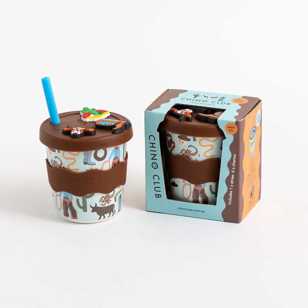 Children's cup with a straw and lid, featuring animal prints, next to its packaging box on a white background.