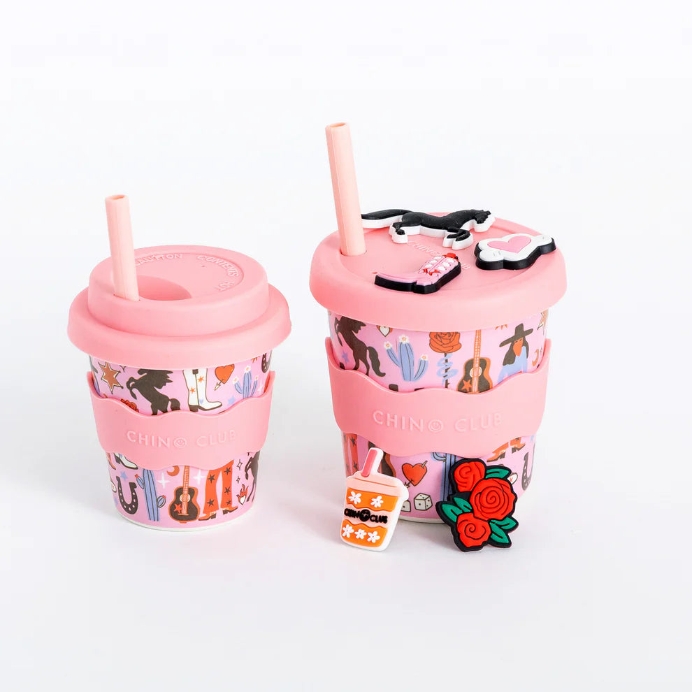 Two pink cups with colorful designs and straws on a white background