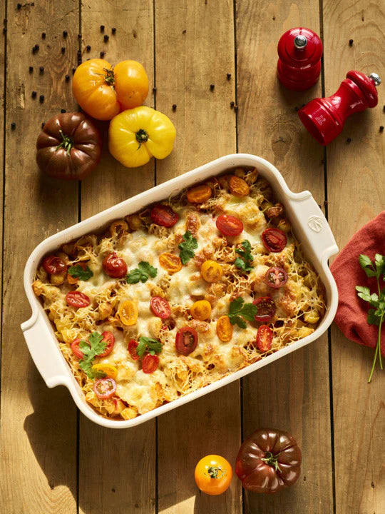 Baked dish with tomatoes on a wooden table