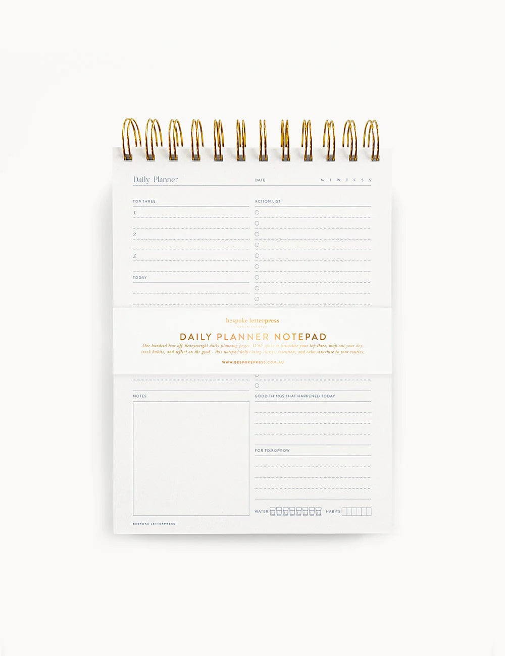 Daily planner notepad with gold accents on a white background
