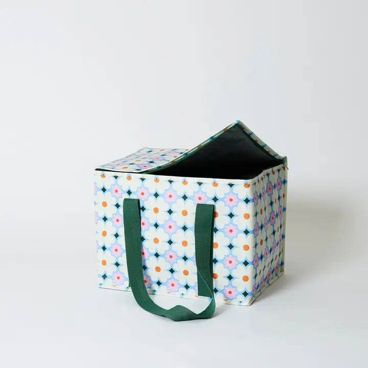 Storage cube with floral pattern and green handles on a white background