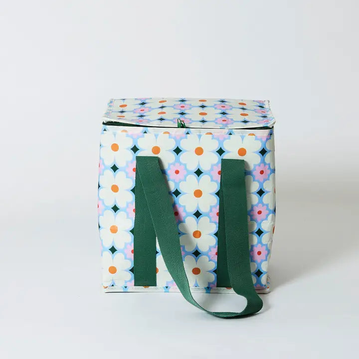 Square fabric bag with floral pattern and green handles on a white background