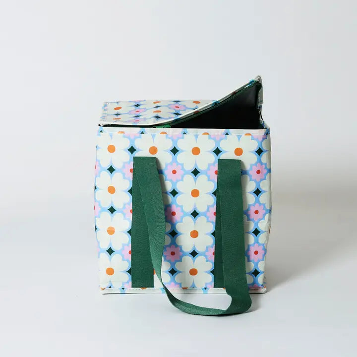 Tote bag with floral pattern and green handles on a white background