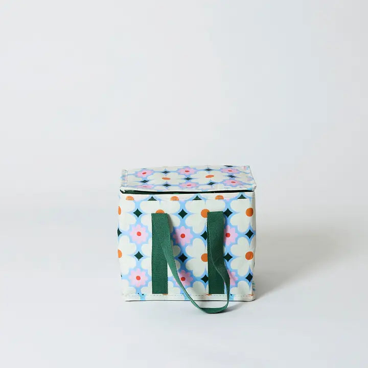 Colorful patterned bag with green handles on a white background