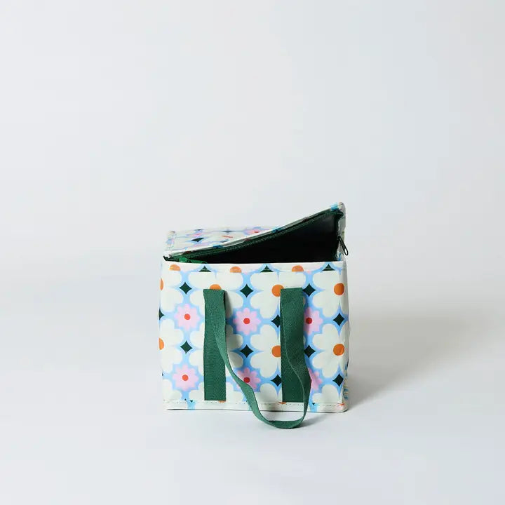 Small rectangular bag with a colorful geometric pattern and green handles on a white background