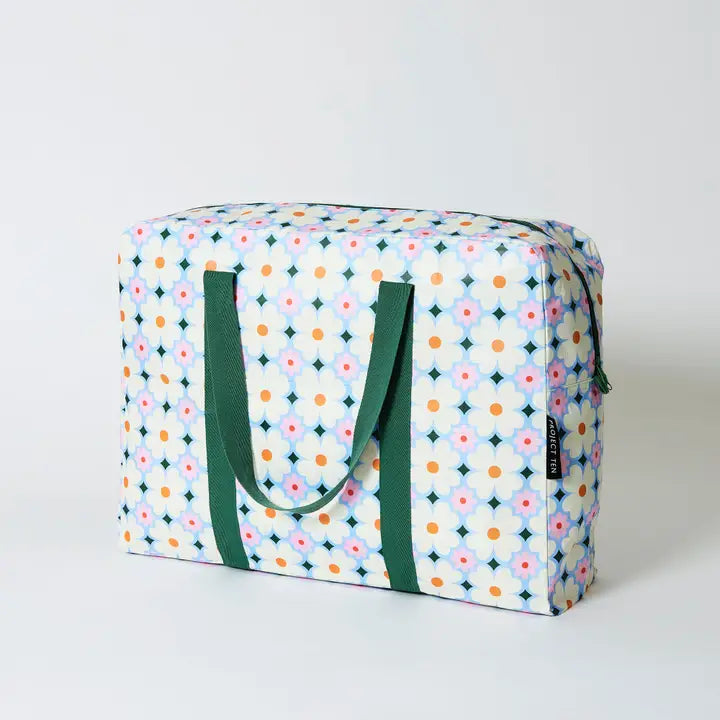 Patterned storage bag with green handles on a white background