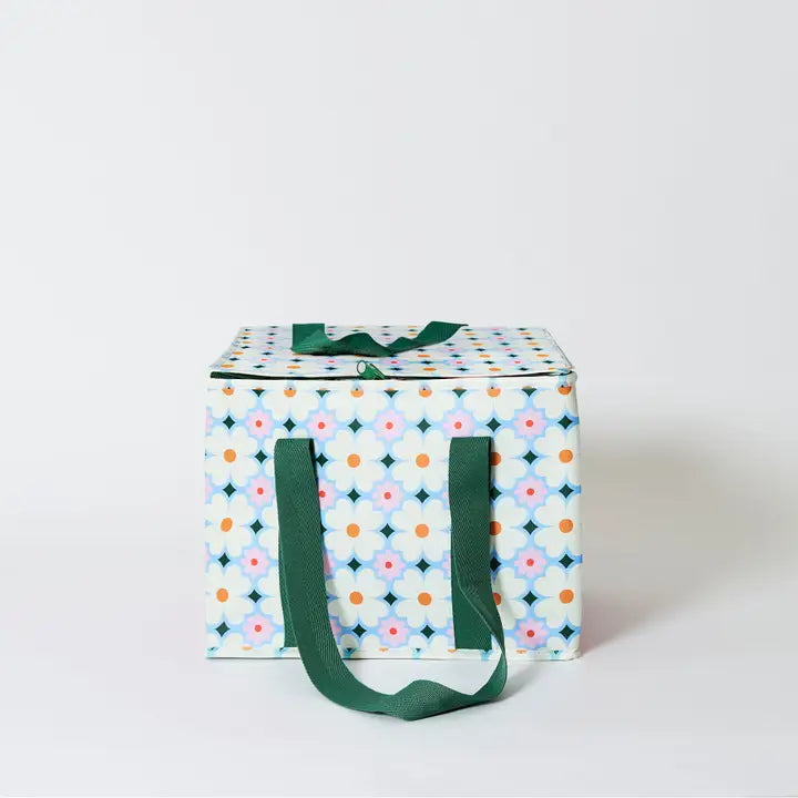 Storage box with floral pattern and green handles on a white background