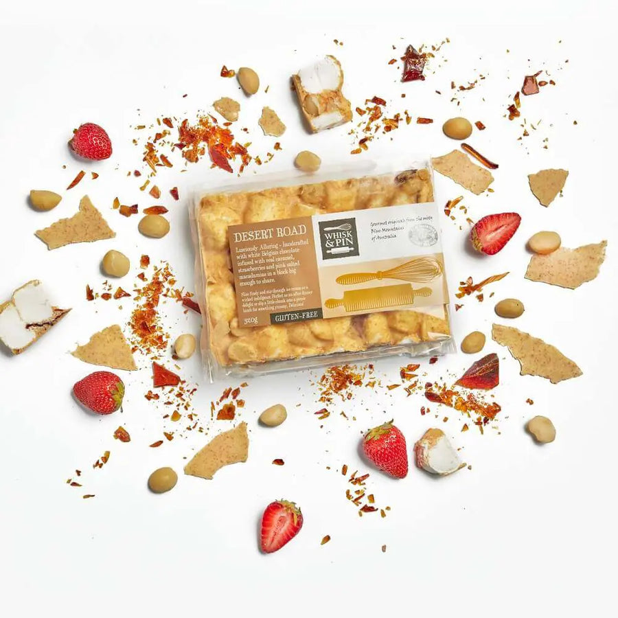 Packaged rocky road with strawberries and cookies on a white background