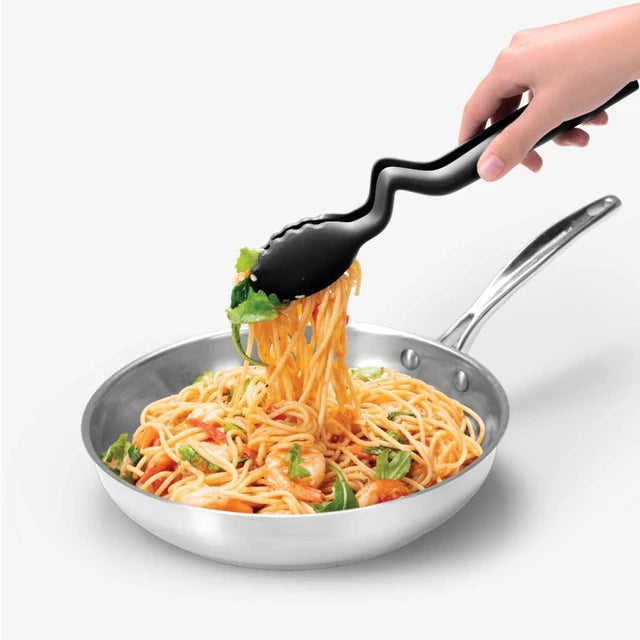 Person using tongs to serve spaghetti from a pan on a white background