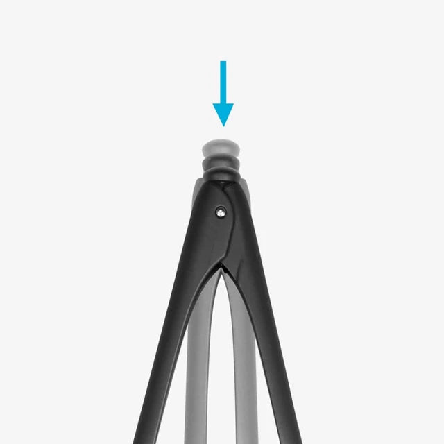 Close-up of button at the top of tongs, on a white background.