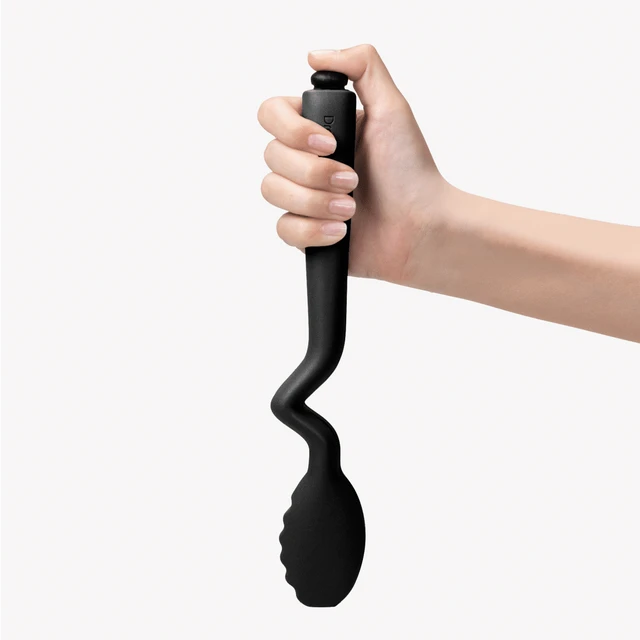 Hand holding black kitchen tong against a white background