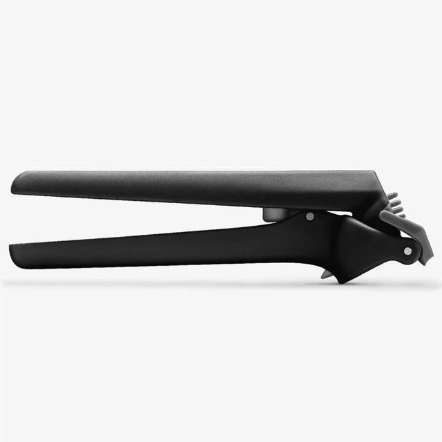 Black garlic press on a white background