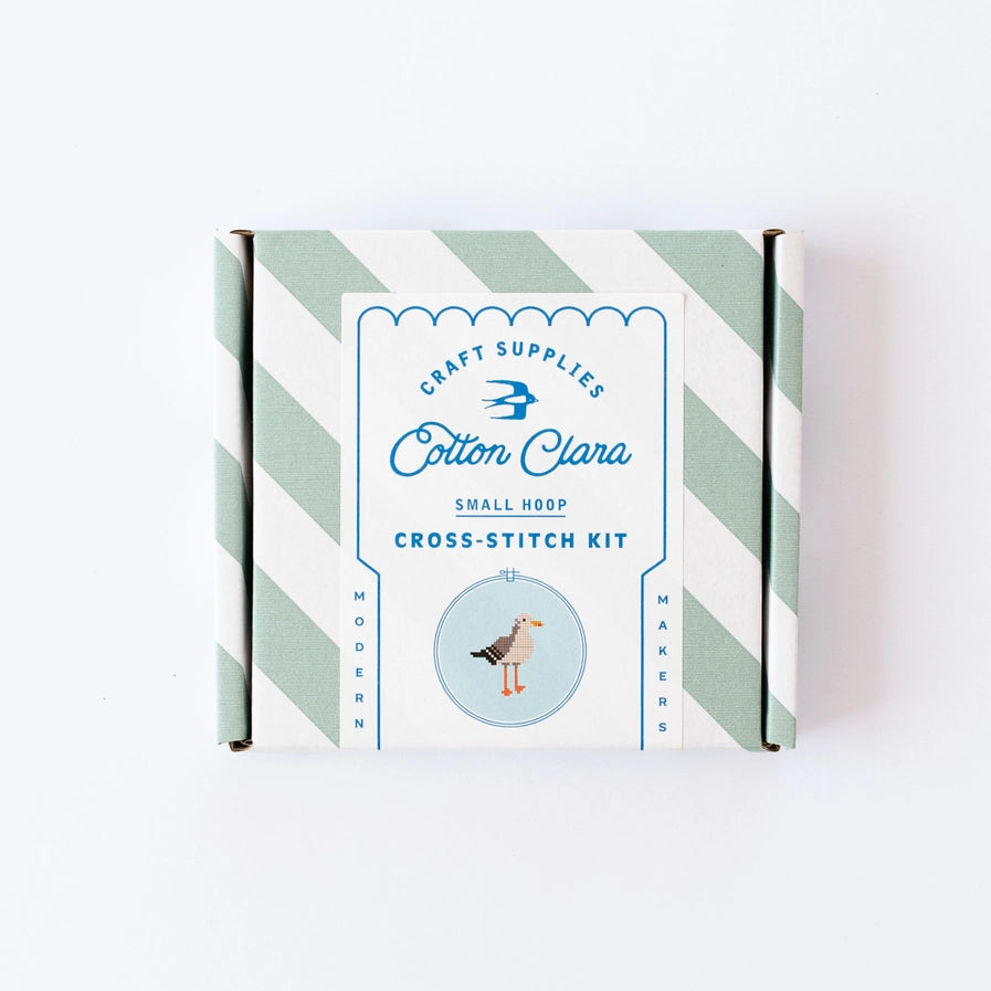 Cotton Clara cross-stitch kit packaging with striped design on a white background