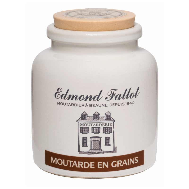 Seeded French mustard in a white stoneware pot on a white background