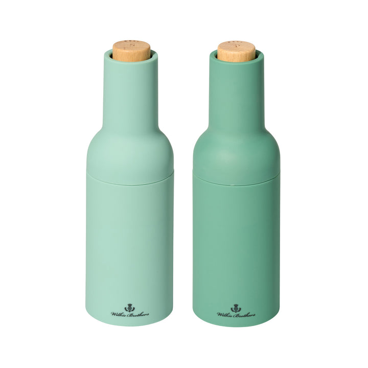 Two green salt and pepper shakers with wooden tops on a white background