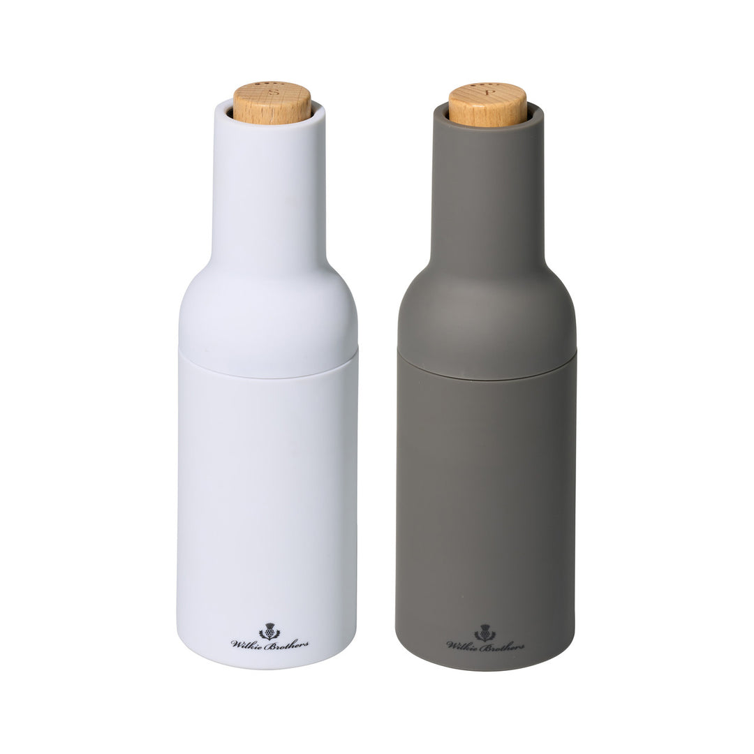 Salt and pepper mills, one white and one gray, with wooden caps on a white background.