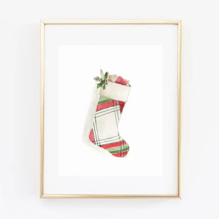 Framed artwork of a Christmas stocking with plaid pattern on a white background