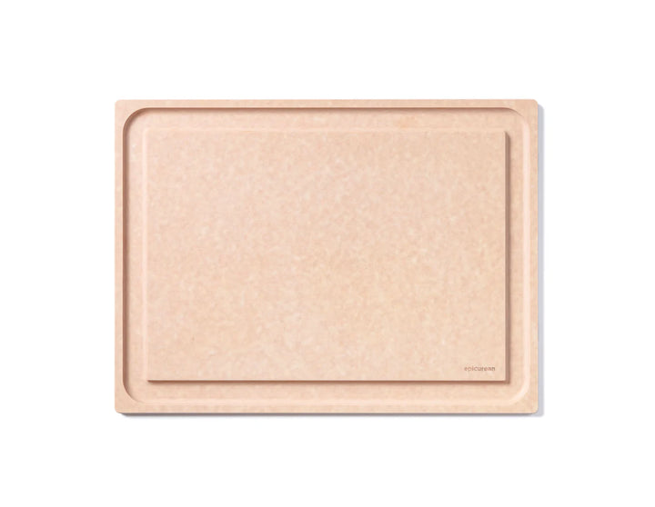 Beige compressed wood cutting board with a subtle pattern on a white background