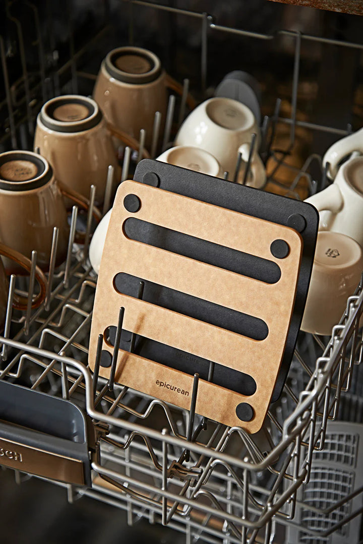 Wooden trivets with black handles in a dishwasher rack