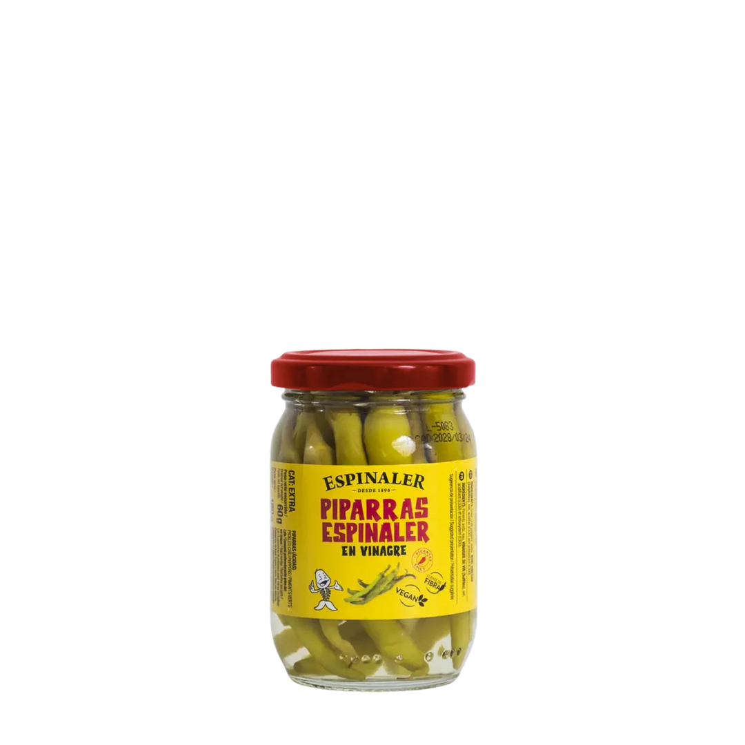 Jar of Espinaler pickled peppers with a red lid on a white background