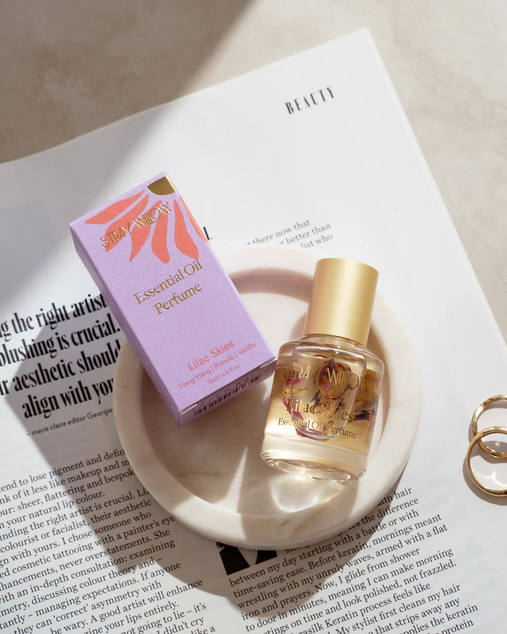 Essential oil perfume bottle and packaging on a magazine