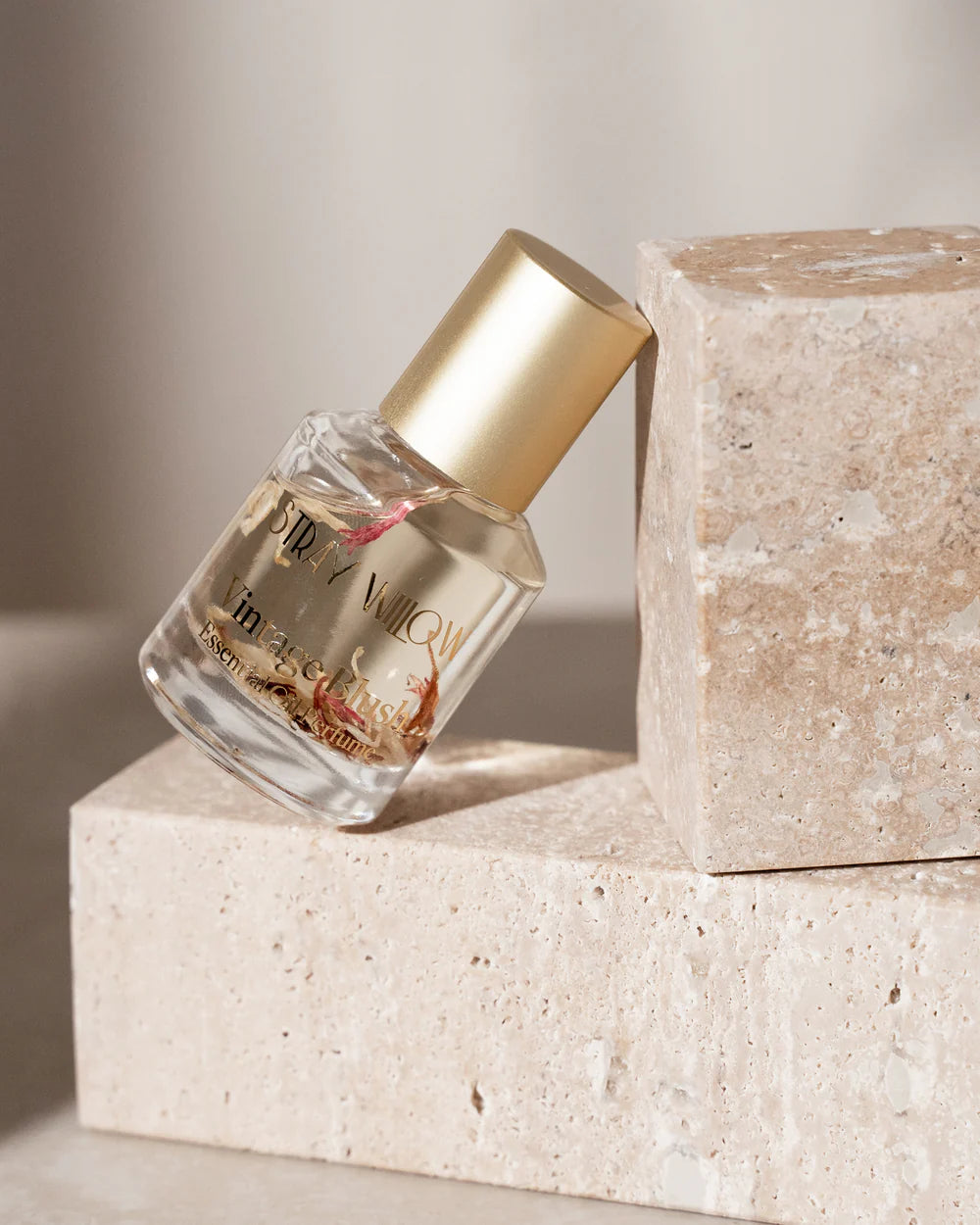Small bottle with gold cap on a stone surface