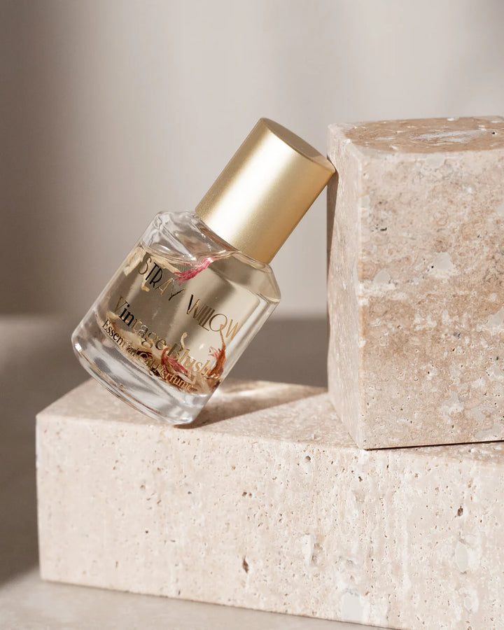 Small bottle with gold cap on a stone surface