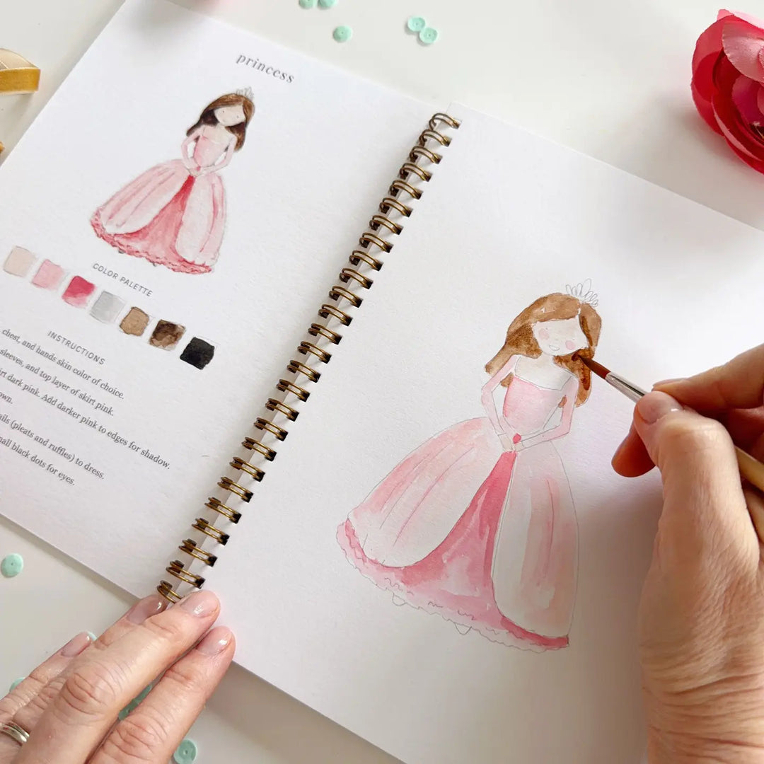Person drawing a princess in a pink dress in a sketchbook with color swatches.
