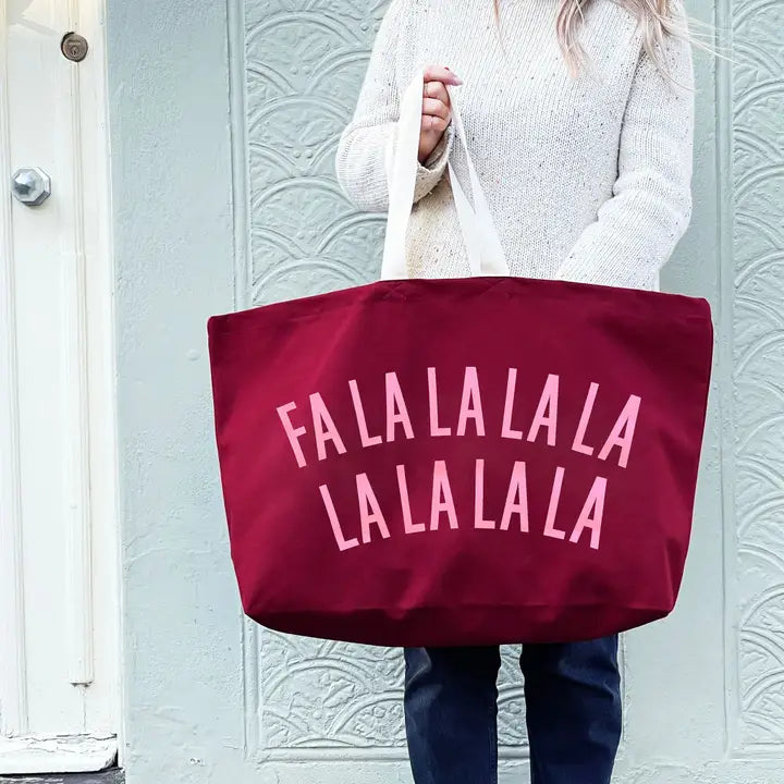 Person holding a red tote bag with &
