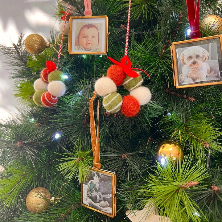 Decorative Christmas tree with colorful ornaments and framed photos