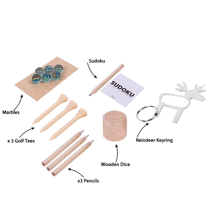 Collection of items including marbles, golf tees, pencils, dice, a Sudoku set, a reindeer keyring, and a wooden block on a white background.