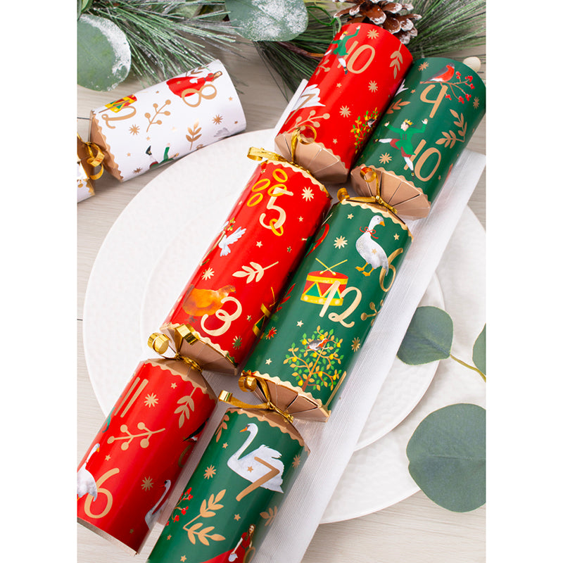 Decorative Christmas crackers with festive designs on a white surface.