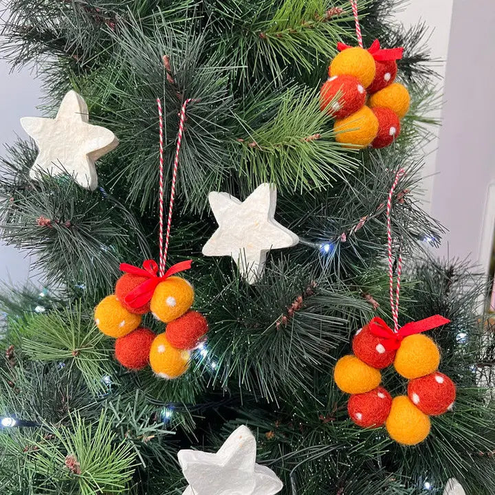 Decorative Christmas tree with star-shaped ornaments and colorful spherical decorations.