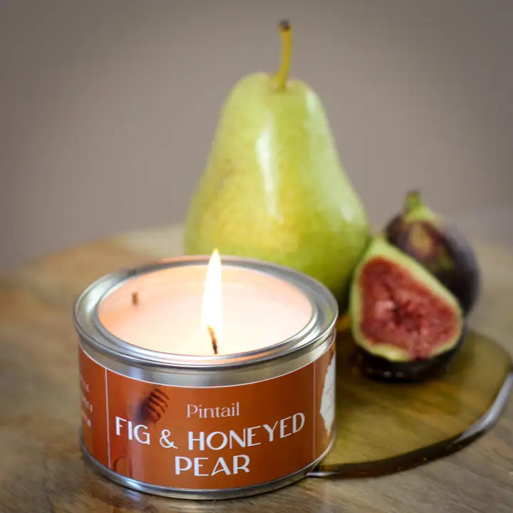 Fig & honeyed pear candle in a paint pot with fresh pear & figs in the background